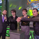 The three members of Splyce’s World of Warcraft team gripping the trophy after winning the championship.